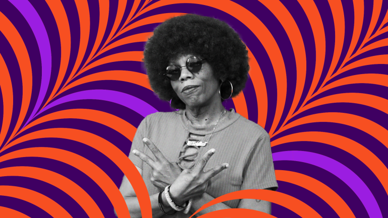 DJ Lady Love makes two peace signs with her arms crossed in front
