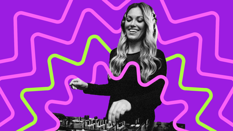 Sloane Motion looking down at decks, smiling as she DJs