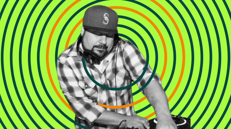 DJ Tamm t plays while holding headphones in place with shoulder
