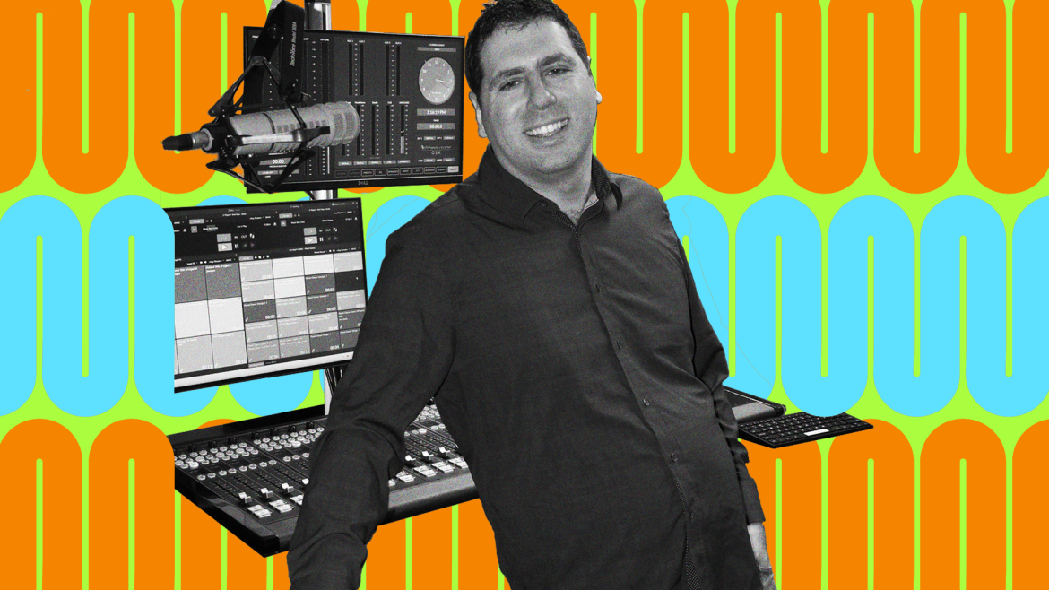 Matt leans back while smiling at the camera, recording equipment behind him