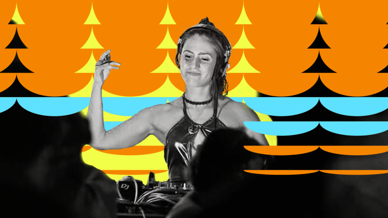 Madlon DJing while smiling and looking down at the decks