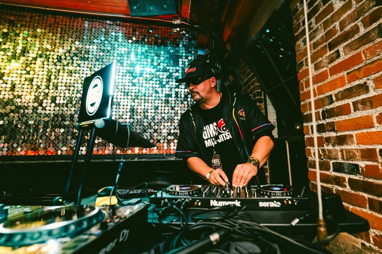 A DJ set up against a sparkling backdrop