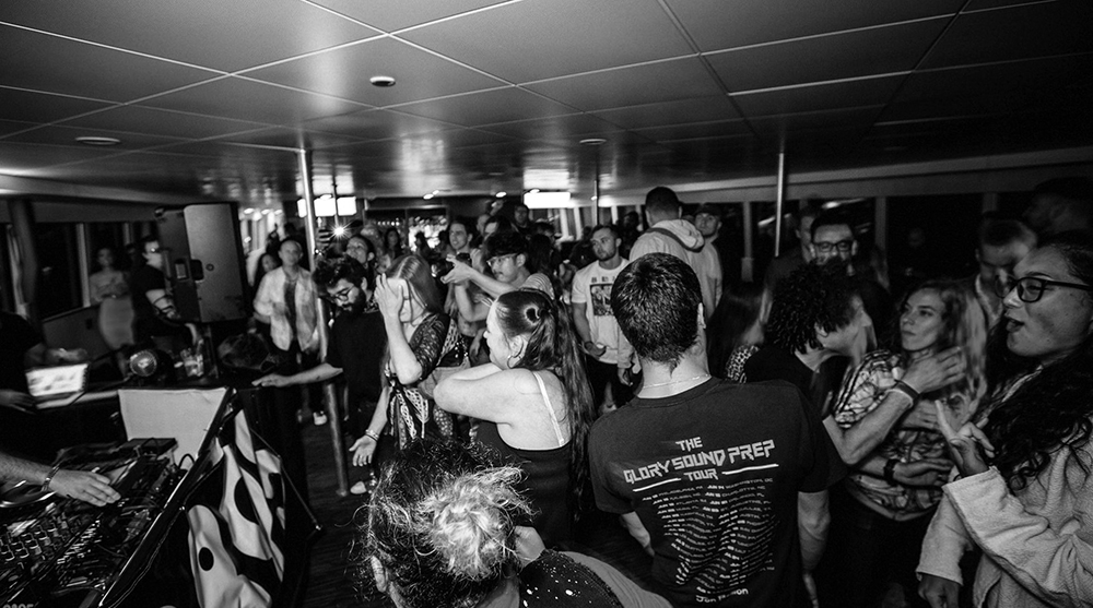 A crowded room filled with diverse people dancing