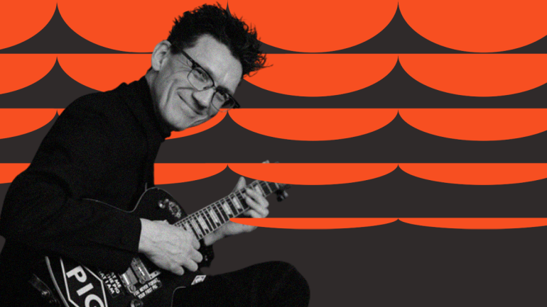 A person is playing a guitar with the word "PIG" visible on it. The background features an abstract design of orange and black semicircles.