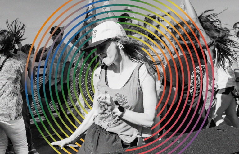 A group of people dancing energetically outdoors. The image is overlaid with colorful concentric circles creating a dynamic effect.