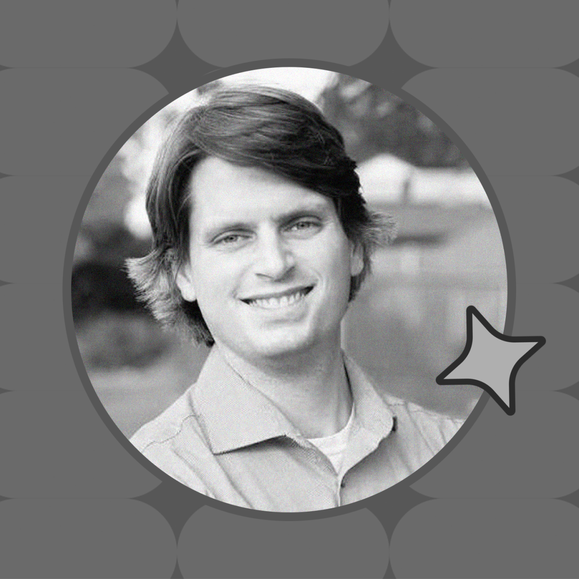 An image of a man smiling with a patterned background